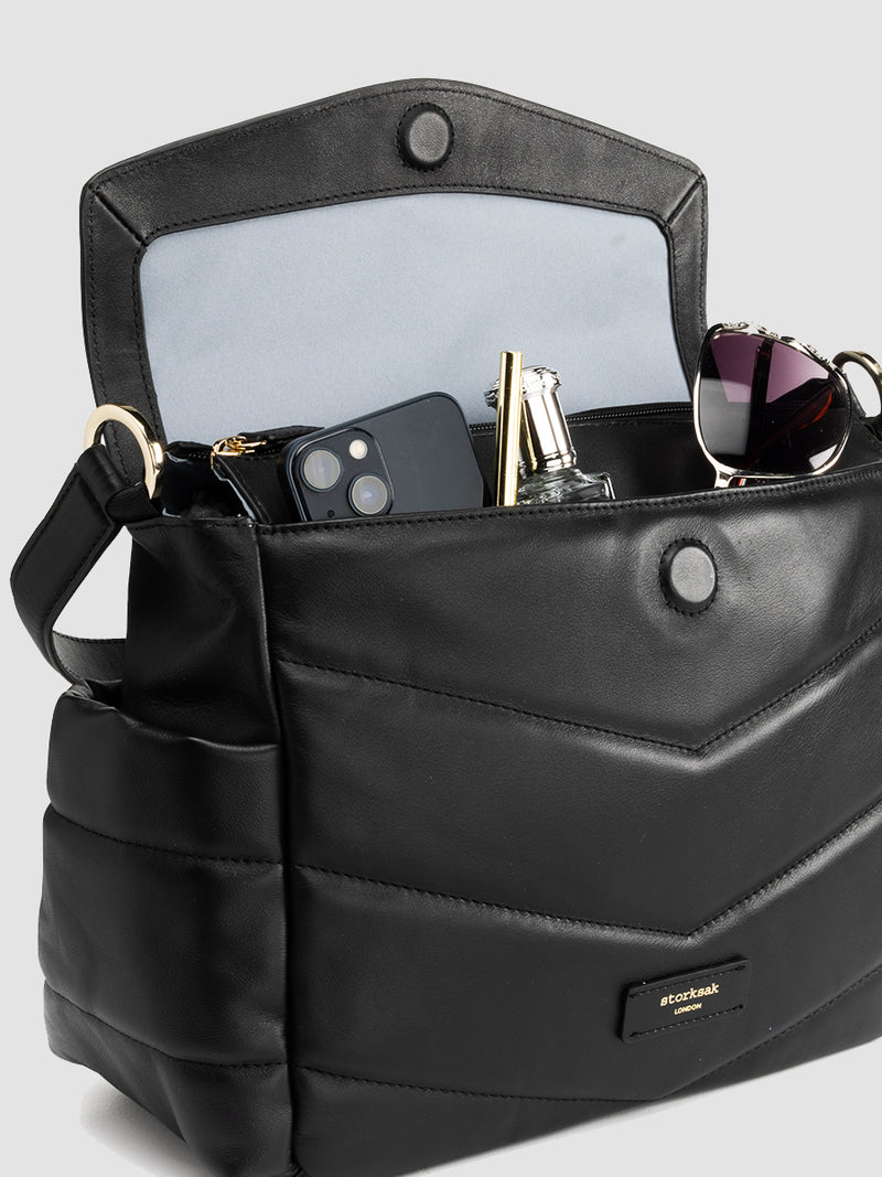 Storksak Aria Leather Compact Change Bag | bag open with mum items in front pocket