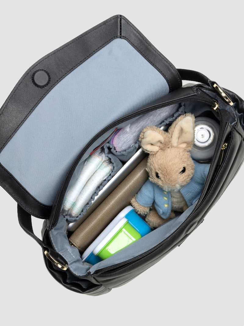 Storksak Aria Leather Compact Change Bag | internal view with baby items inside