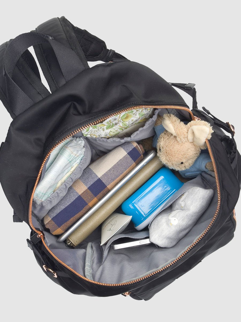 storksak hero quilt black, changing bag backpack, in quilted nylon with rose gold hardware, main internal full of baby clothes, nappies etc
